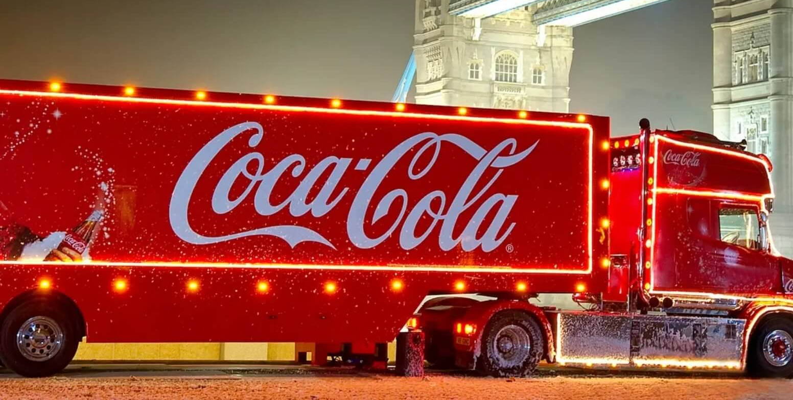 Coca-Cola illuminated delivery truck in front of Tower Bridge